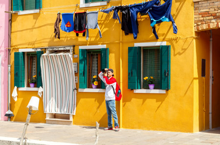 Venice, Italy - May 21, 2015: The island in the lagoon near Venice. Famous tourist attraction. Famous for its colorful houses and lace.のeditorial素材