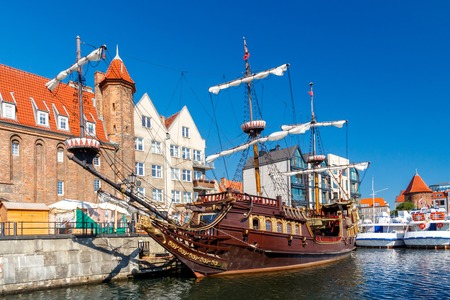 Pleasure craft and colorful facades of the houses on the central waterfront in Gdansk.の写真素材