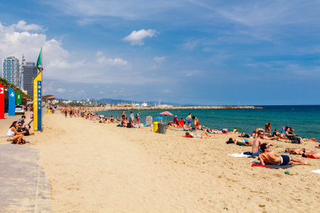 Barcelona, Spain - September 5, 2015: Barceloneta is one of the most popular city beaches of Barcelona. Many tourists come here to sunbathe, swim and play sports.のeditorial素材