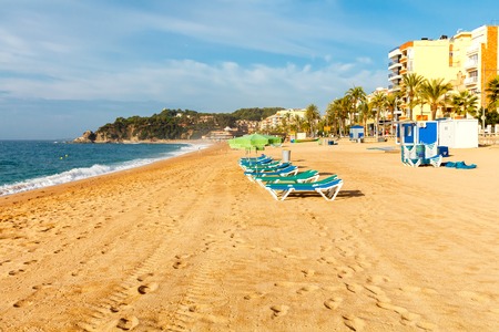 Deckchairs on the beach of Lloret de Mar in the early morning.の写真素材