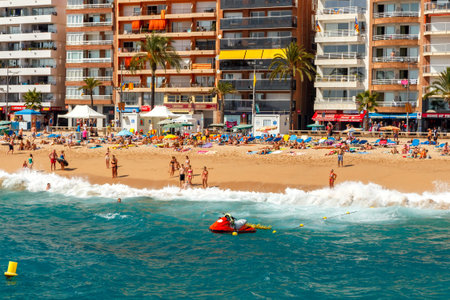 Lloret de Mar, Spain - September 13 2015: A crowd of vacationers enjoy the warm beaches of the Costa...
