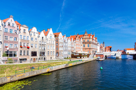 Facades of medieval houses in the center of Gdansk waterfront along the river Motlawa old.の写真素材