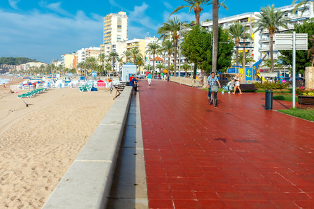 Lloret de Mar, Spain - September 13 2015: A crowd of vacationers enjoy the warm beaches of the Costa Brava in Lloret de Mar. Lloret de Mar is one of the largest resorts on the coast of Spain.のeditorial素材