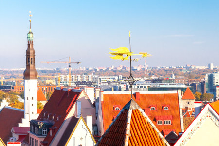 Tallinn, Estonia - 17 October, 2015: The spiers, weather vanes, the roofs of the old city on the background of modern buildings. In Tallinn successfully combined old and modern architectural styles.のeditorial素材