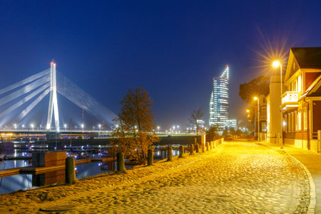 Modern cable-stayed bridge across the Daugava River in Riga night.