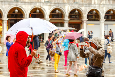 Venice, Italy - May 22, 2015: People under umbrellas on a rainy day in Venice. Because of the proximity to the sea in Venice is often the rain comes.のeditorial素材