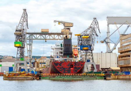 The ship is repaired in a large marine dock.の写真素材
