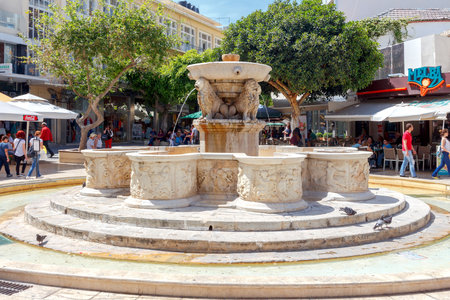 Heraklion, Greece - April 24, 2016: A beautiful stone fountain with sculptures in the capital of Crete. The area around the fountain is a favorite holiday destination for residents and tourists.のeditorial素材