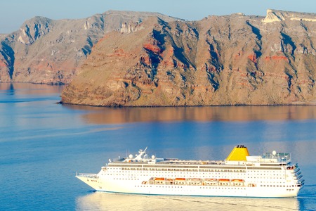 Beautiful landscape with sea and passenger ship near island Nea Kameni. Santorini, Greece.の写真素材
