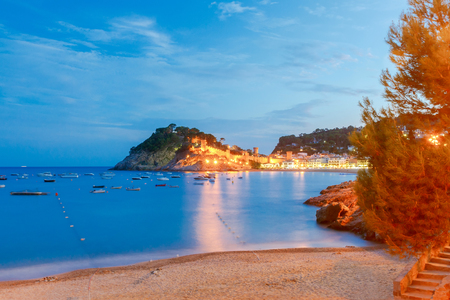 Night view of ancient fortress and Badia de Tossa bay in Tossa de Mar on Costa Brava, Catalunya, Spain.の写真素材