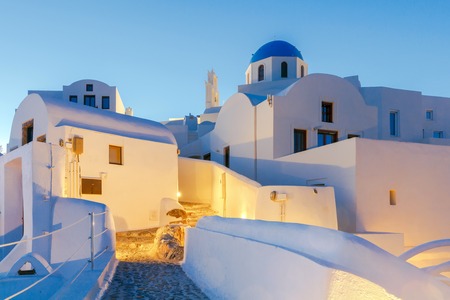 The traditional architecture of Santorini and the view of the white Greek church at sunset.の写真素材