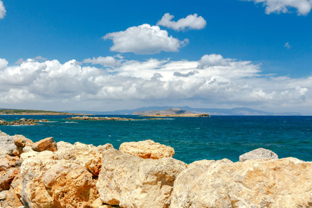 Sea views, waves and stones on a sunny day. Crete. Greece.