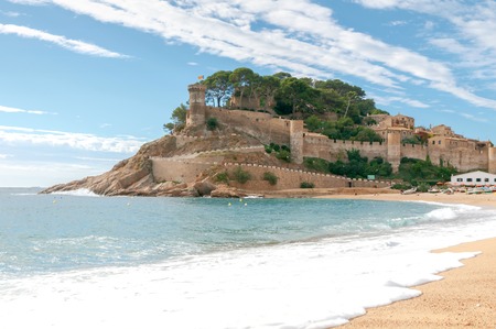 Sandy beach at Tossa de Mar in the early morning in September.の写真素材