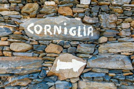 A pointer to a stone wall on the path from the village Vernazza to Corniglia.の写真素材