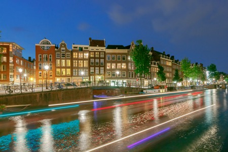Facades of traditional Dutch houses on the canal in the night light. Amsterdam. Netherlands.の写真素材