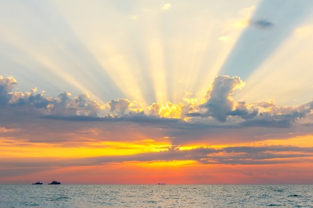 Picturesque views of the outgoing to the horizon the sun and the ships at sea.の写真素材