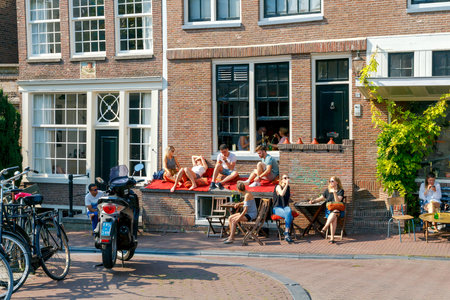 Amsterdam, The Netherlands - August 27, 2016: Traditional dutch houses on the canal. The main tourist attraction.のeditorial素材