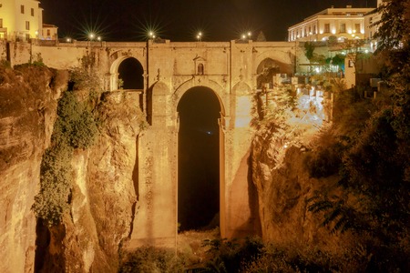 The unique stone bridge across the gorge in the village Ronda. Spain. Andalusia.の写真素材