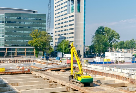 Large excavator in the foundation pit of the construction site.の写真素材