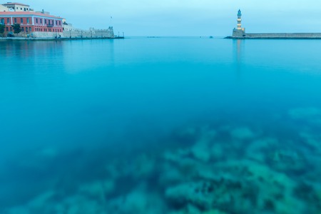 Lighthouse in the old harbor of Chania, on a background of blue sea.の写真素材