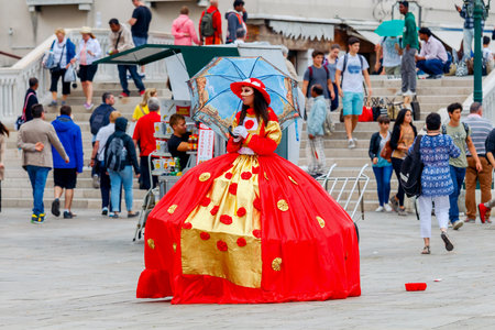 Venice. A woman in an old dress and carnival mask.のeditorial素材
