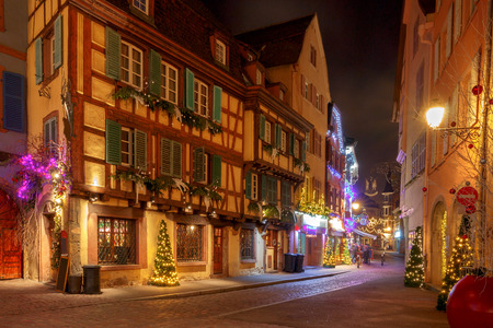 Traditional old half-timbered houses in the historic city of Colmar. Decorated and lighted during the Christmas season. Alsace. France.の写真素材