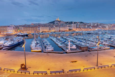Panoramic view of the old port and the Cathedral of Notre Dame at sunset in the night lighting. Marseilles. France.の写真素材