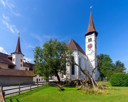Interlaken. White catholic church with a bell tower on a sunny morning.の写真素材