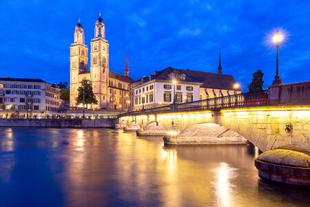 Zurich. View of the city embankment and the church Grossmunster at sunset.の写真素材