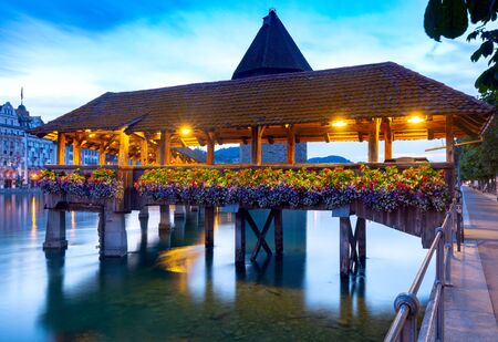 Lucerne. The famous Chapel, Kapellbrucke bridge at dawn in night lighting.の写真素材