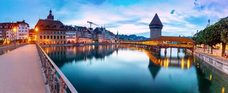 Lucerne. The famous Chapel, Kapellbrucke bridge at dawn in night lighting.の写真素材