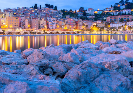 Menton. Antique multi-colored facades of medieval houses on the shore of the bay.の写真素材
