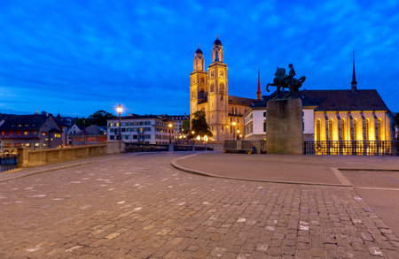 Zurich. View of the city embankment and the church Grossmunster at sunset.の写真素材