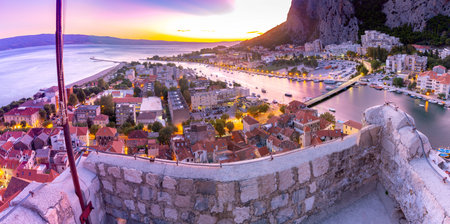Panoramic views of the city, mountains and coast at sunset. Omis. Croatia.