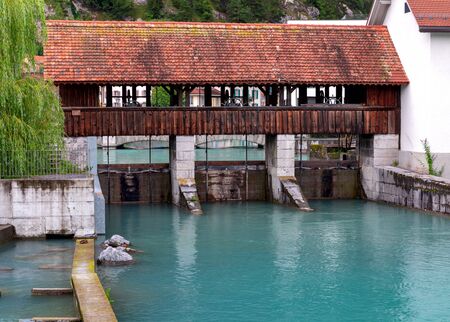Interlaken. Old wooden dam on the mountain river Aare.の写真素材