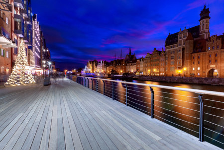 City embankment and facades of medieval houses in the old city at sunset. Gdansk. Poland.