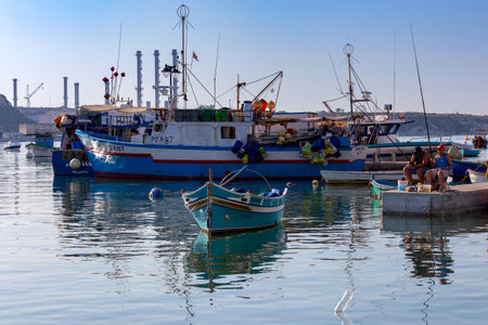 Marsaxlokk, Valletta - July 6, 2019 : Traditional fishing boats in the bay of the village of Marsaxlokk. Malta.のeditorial素材