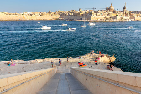 Marsaxlokk, Valletta - July 7, 2019 : Scenic view of the old city and the bay at sunset. Valletta Malta.のeditorial素材