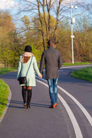 Poznan. A couple of people walking on the embankment.の写真素材