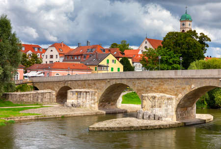 Regensburg. Embankment and old stone bridge over the Danube river.の写真素材