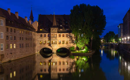 Nuremberg. Old stone buildings above the canal at sunset.の写真素材