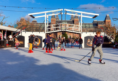 Peoples skating on an ice rink with the Rijksmuseum in the background.のeditorial素材