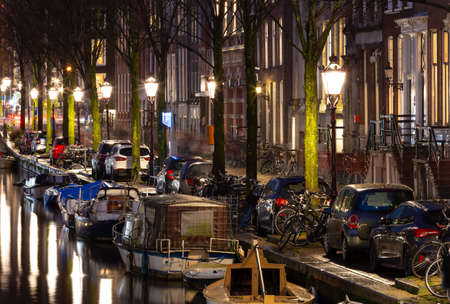 Beautiful old houses on the city waterfront of Amsterdam at sunset.の写真素材