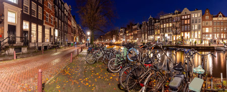 Beautiful old houses on the city waterfront of Amsterdam at sunset.の写真素材