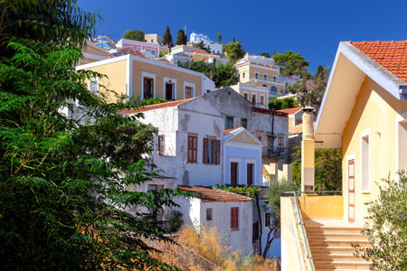 Colorful traditional multi-colored houses on the shore of the bay on Symi island.