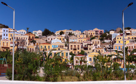 Colorful houses on the slopes of the mountains on the island of Symi on a bright sunny day.