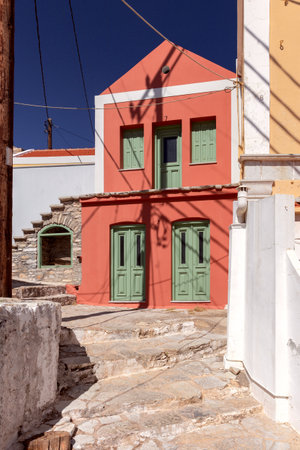 Colorful traditional multi-colored houses on a narrow street of Symi island.の写真素材