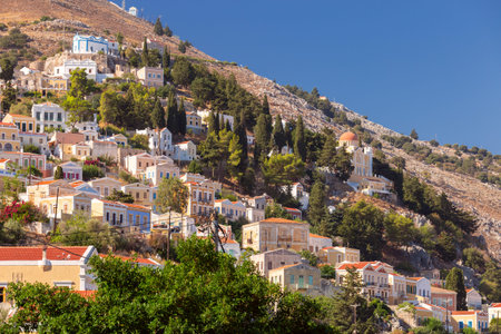 Multi-colored facades of houses in the village Symi on a sunny day.の写真素材