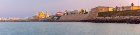 Cathedral of the Holy Cross on the Cadiz waterfront at dawn.の写真素材