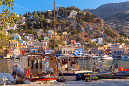 Multi-colored facades of houses in the village of Symi at sunset.の写真素材